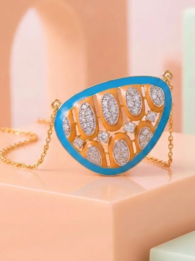 A contemporary pendant inspired by the vibrant rhythm of the sea, featuring cloisonné enamel in azure blue, and sunlit amber. Crafted in 925 silver with gold plating and accented with sparkling Swarovski crystals, it is a bold celebration of colour, artistry, and modern elegance.