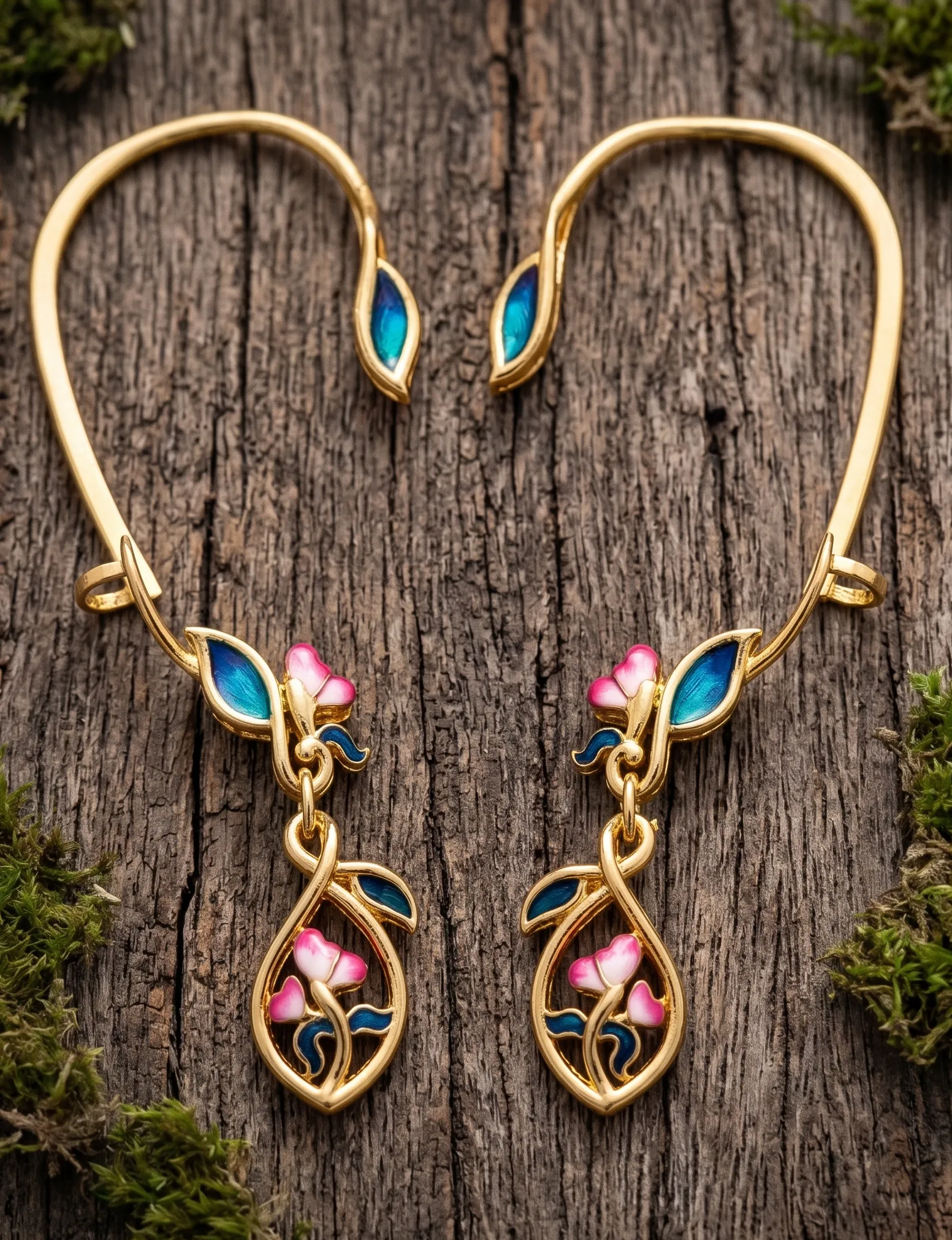 A contemporary pair of statement earrings inspired by blooming vines, featuring vibrant cloisonné enamel in shades of peacock blue, emerald green, and soft blush pink. Crafted in 925 silver with gold plating