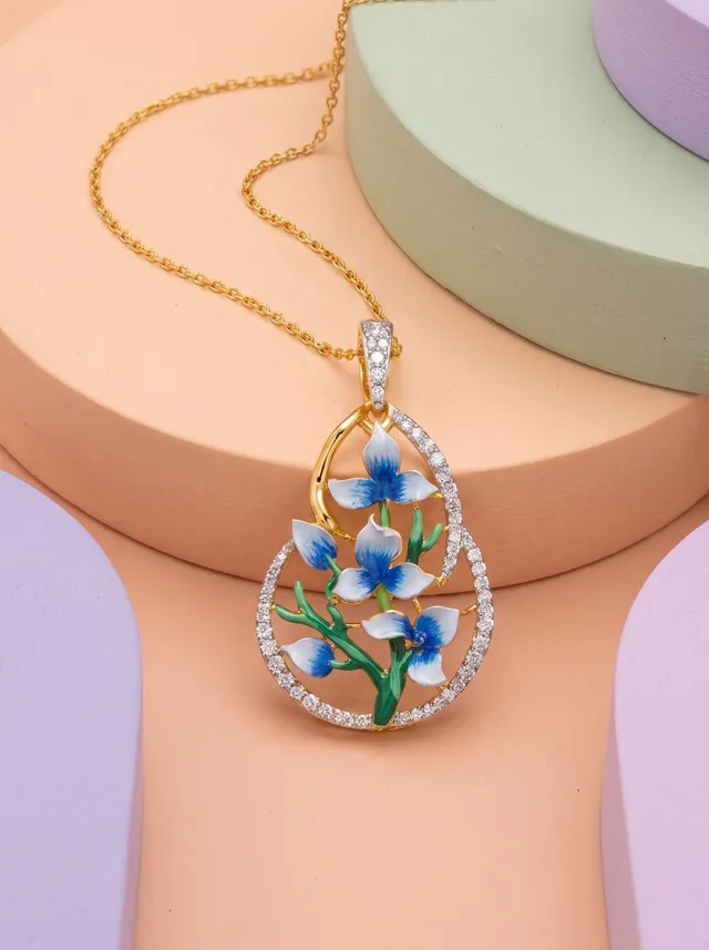 A contemporary pendant inspired by delicate blue blossoms in full bloom. Adorned with Swarovski crystals and hand-finished cloisonné enamel, this elegant piece is crafted in 925 silver with gold plating, bringing together graceful florals, flowing silhouettes, and timeless sophistication.