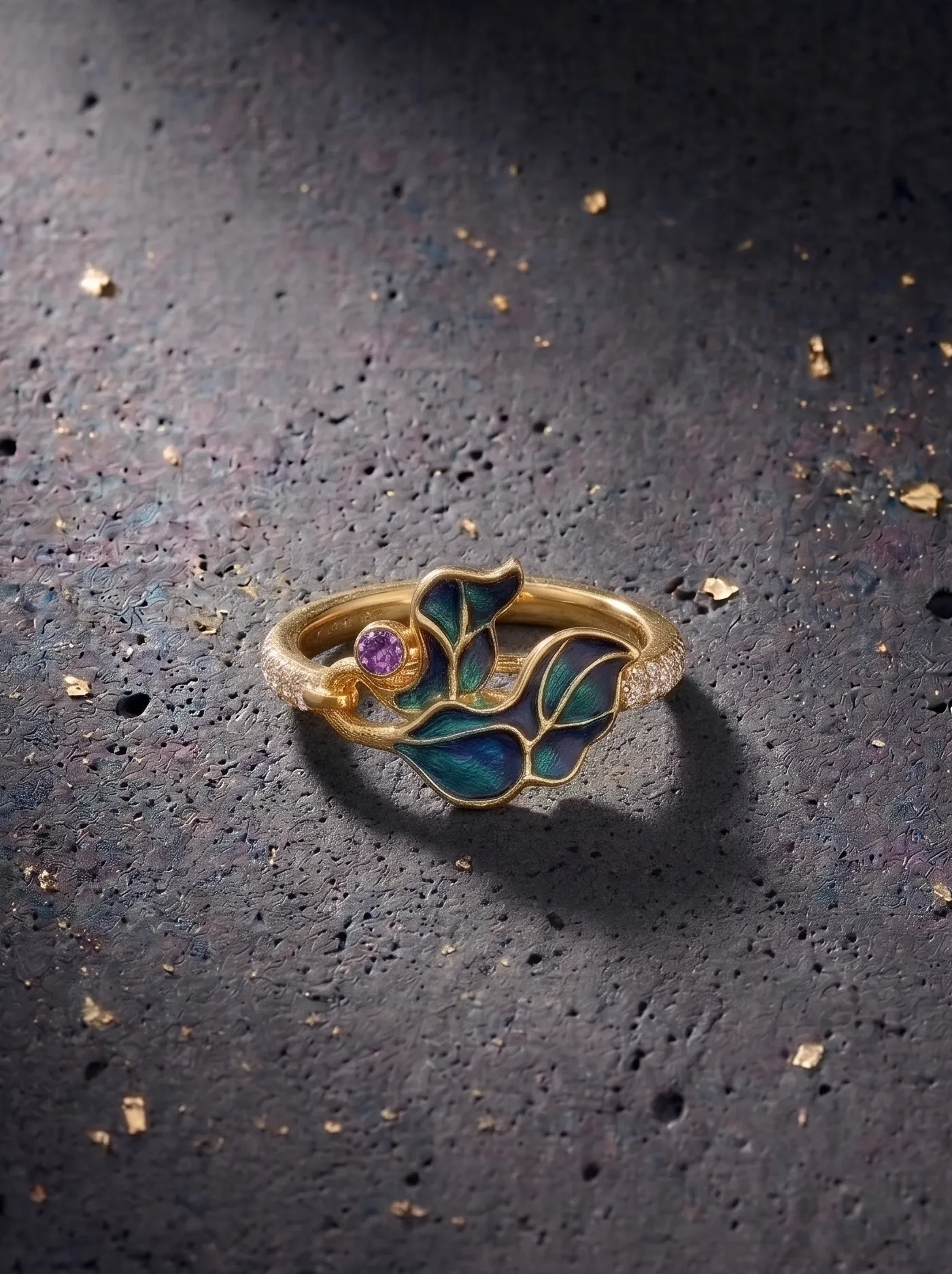 A contemporary ring crafted in 925 gold plated silver, featuring flowing leaf-inspired motifs in vibrant champlevé enamel, accented with a vivid purple stone and Swarovski crystals.