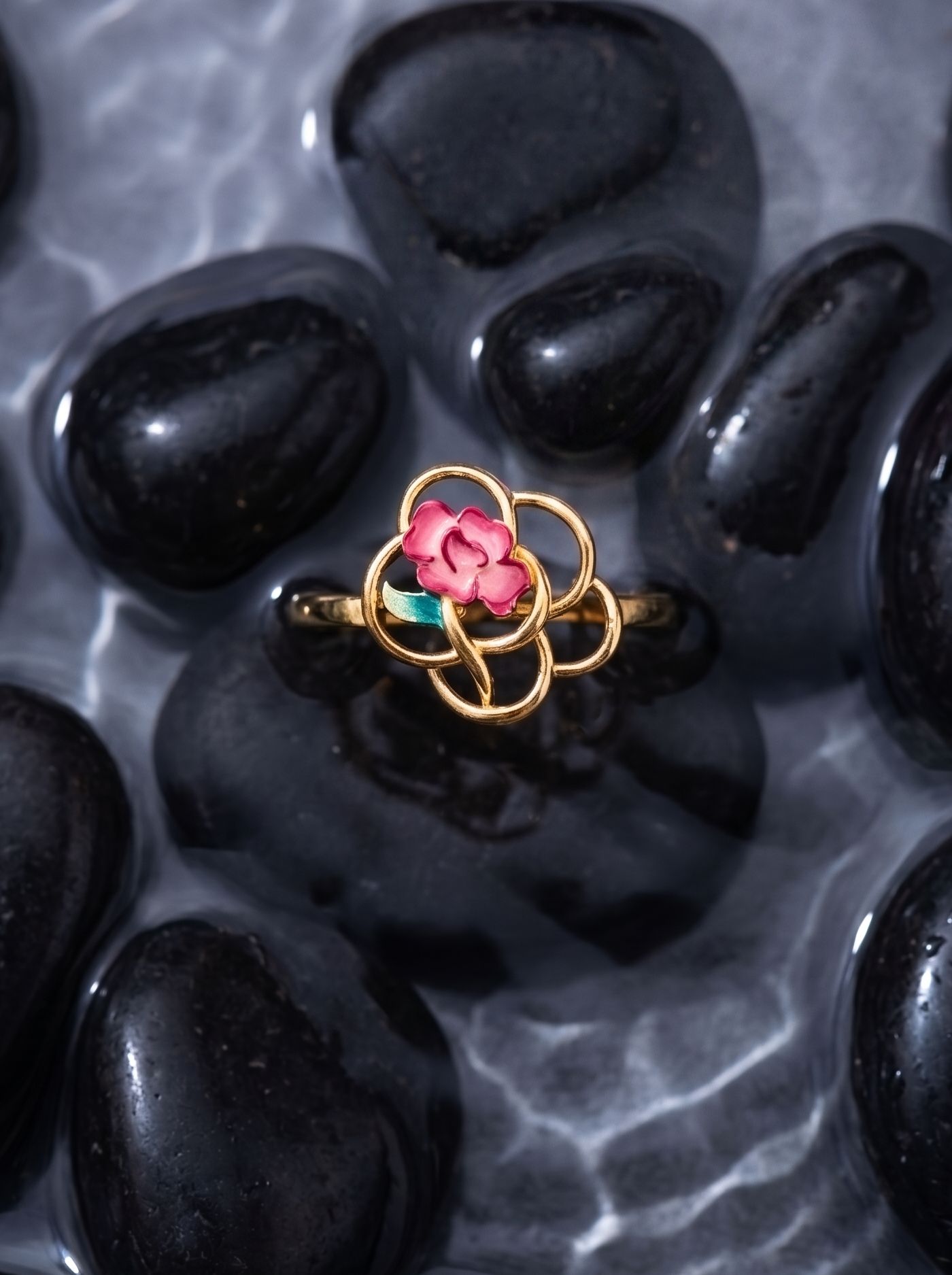A statement ring in 925 gold-plated silver, combining fluid circular forms with hand-finished champlevé enamel roses and Swarovski crystal highlights.